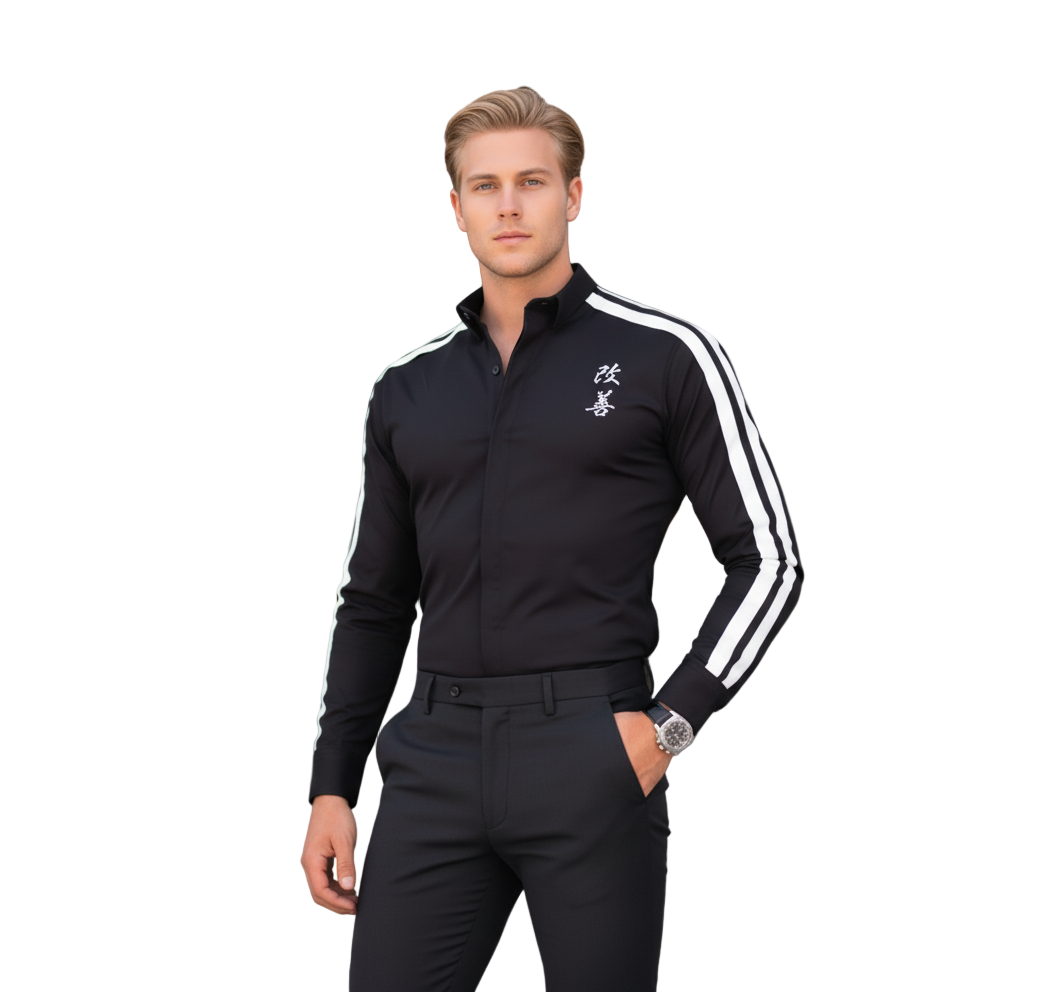 Man wearing a black shirt with white stripes and black pants in front of a modern building.