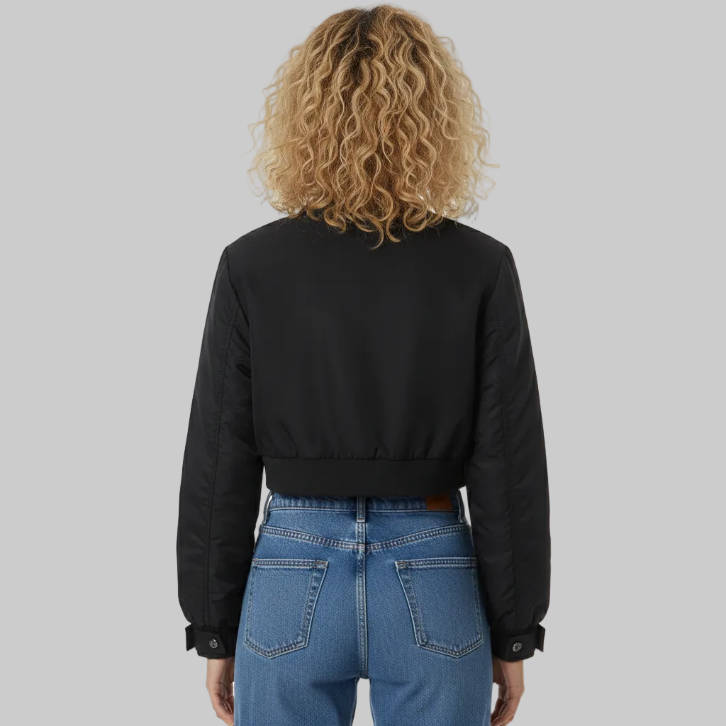 Person wearing a black jacket and blue jeans from behind on a white background