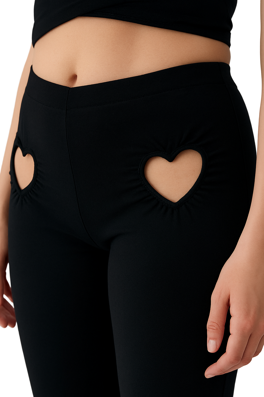 Black leggings with heart-shaped cutouts on a neutral background