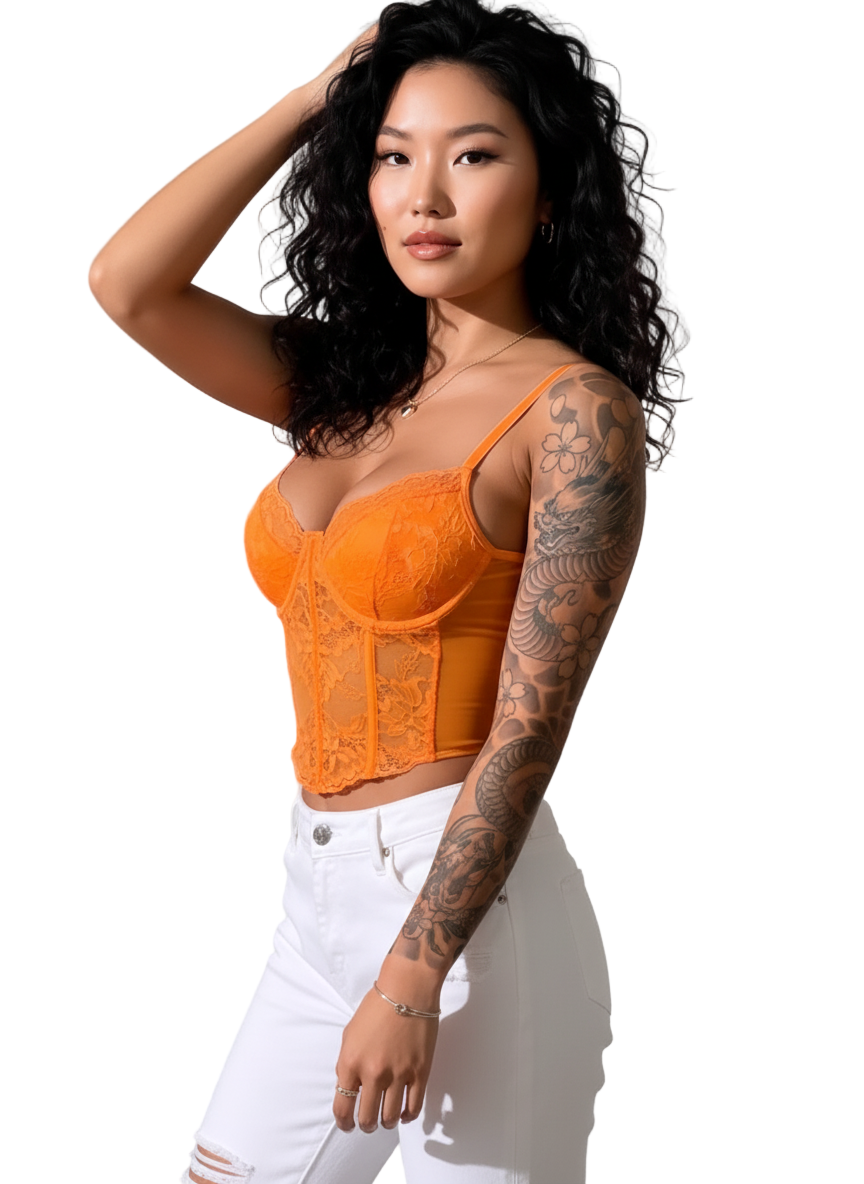 Woman wearing an orange lace top and white pants against a light background