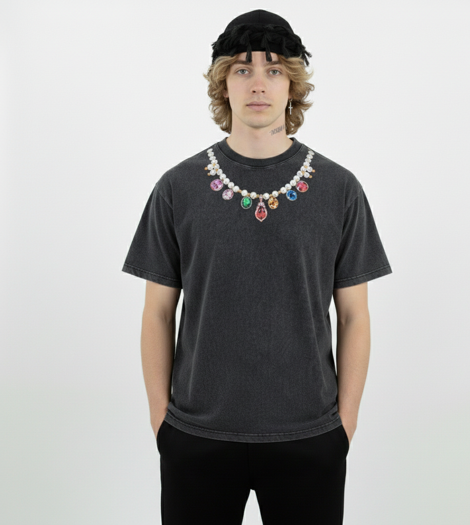 Person wearing a black t-shirt with colorful beads and a black headscarf on a white background