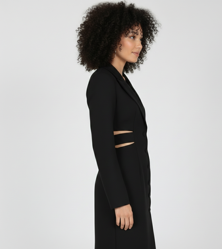 Woman wearing a black coat with cut-out details on a white background