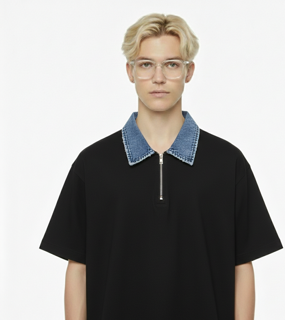Person wearing a black t-shirt with a denim collar on a white background
