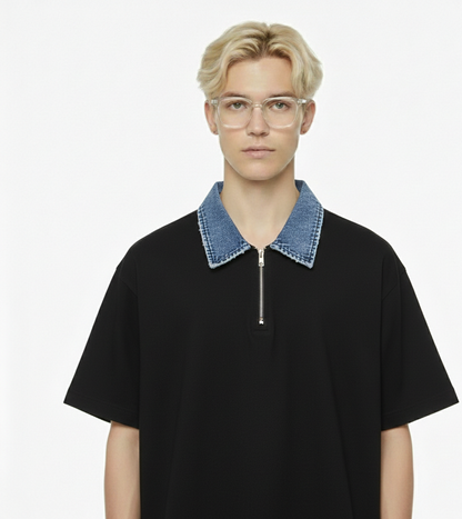 Person wearing a black t-shirt with a denim collar on a white background