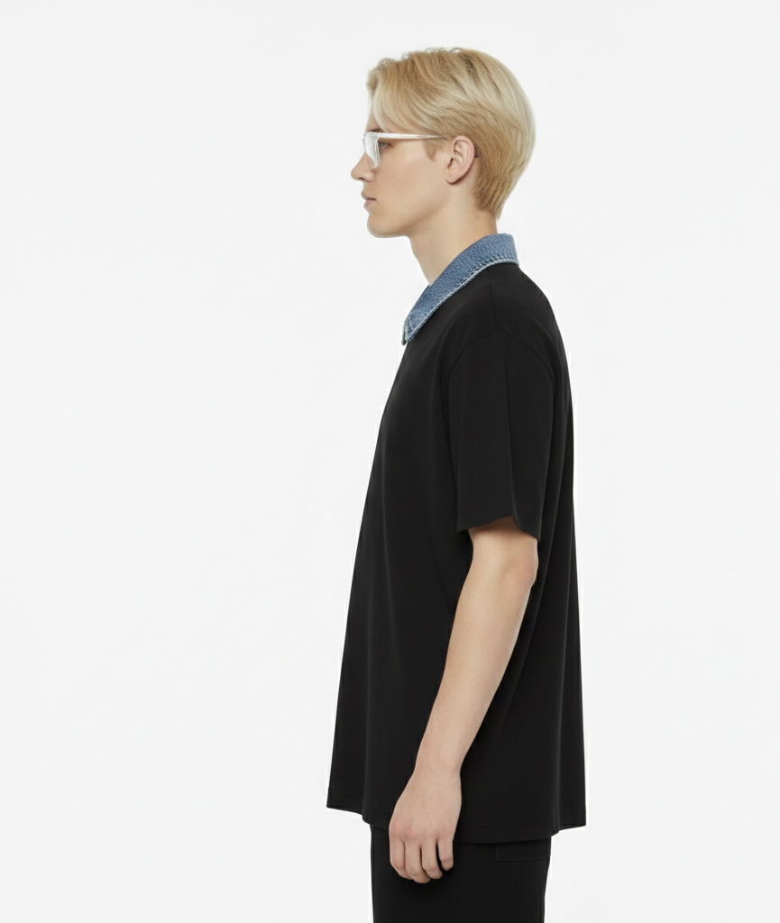 Person wearing a black shirt with a light blue collar on a white background