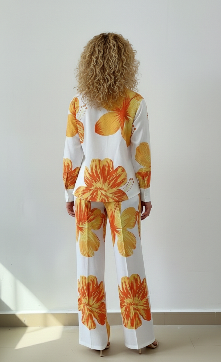 Person wearing a floral outfit with orange flowers on a white background