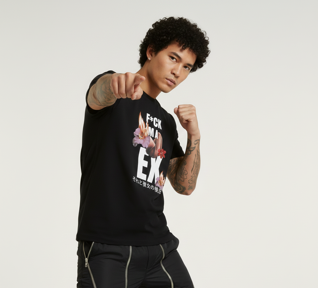 Person wearing a black t-shirt with graphic design and text, standing against a plain background