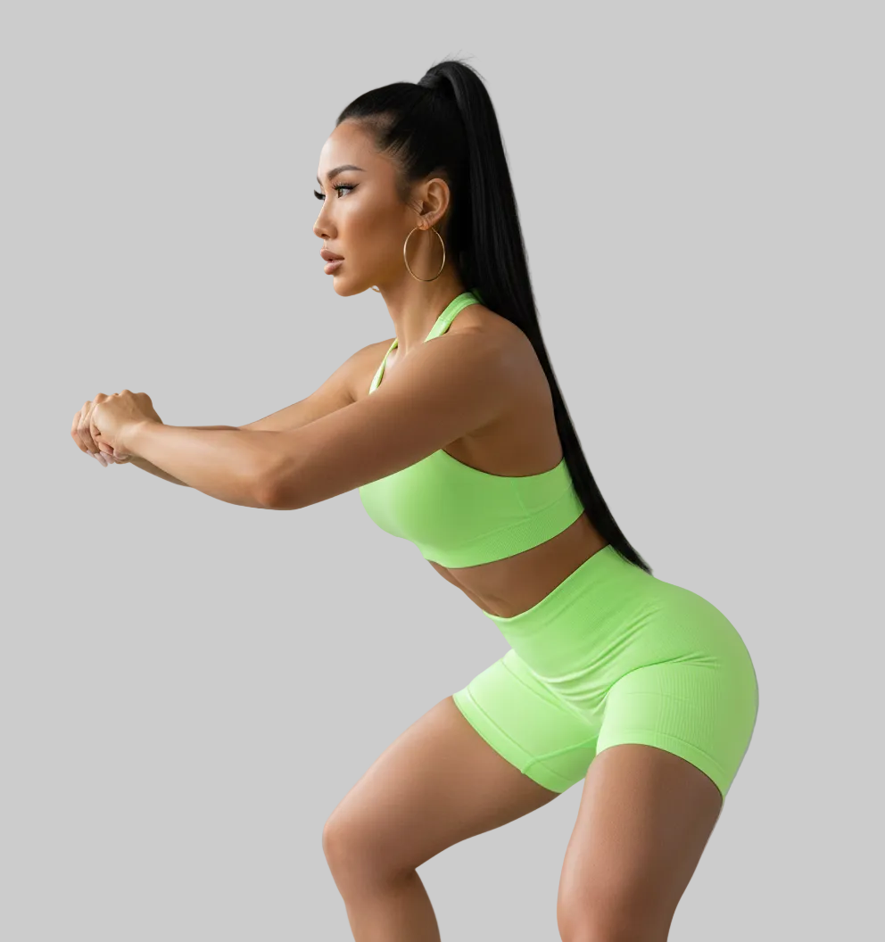 Woman in neon green athletic wear posing in a studio setting