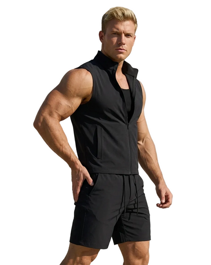 Man wearing a gray sleeveless jacket and shorts on a gray backgroundbackground