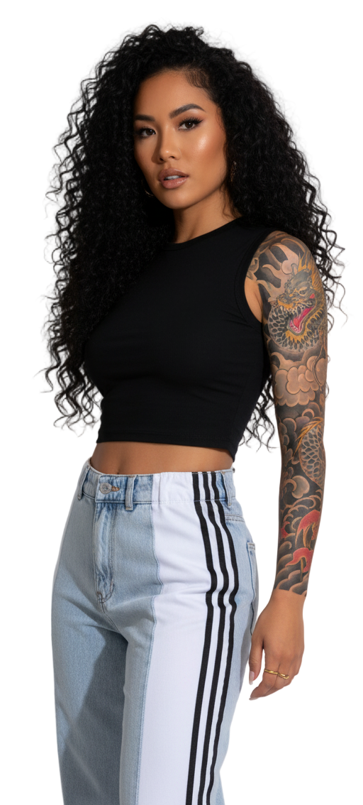 Woman wearing a black crop top and light blue jeans with white stripes on a plain background