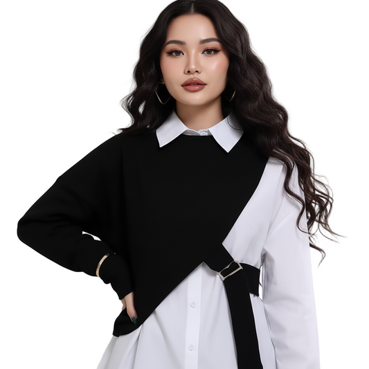 Woman wearing a black and white outfit with a belt on a plain background