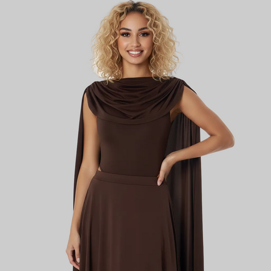 Woman wearing a brown dress with a cape on a white background