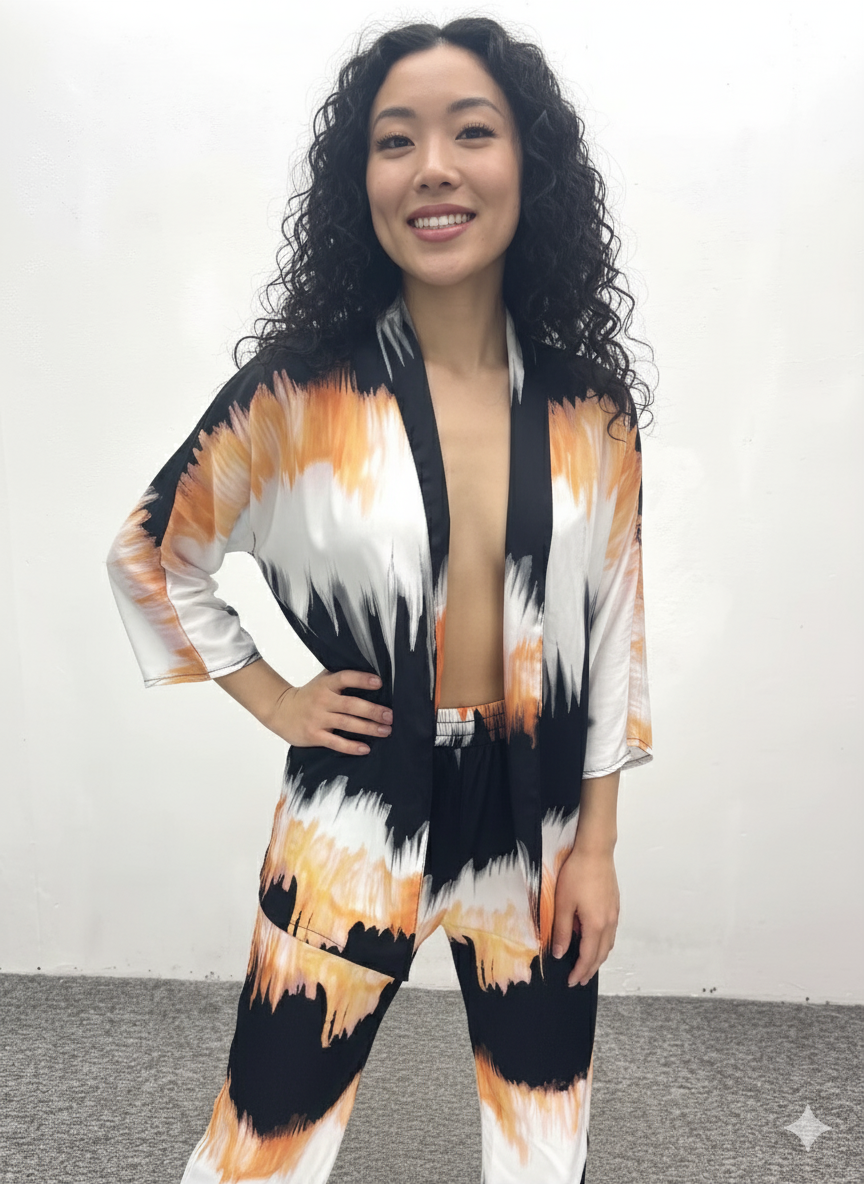 Woman wearing a colorful kimono-style outfit against a plain background