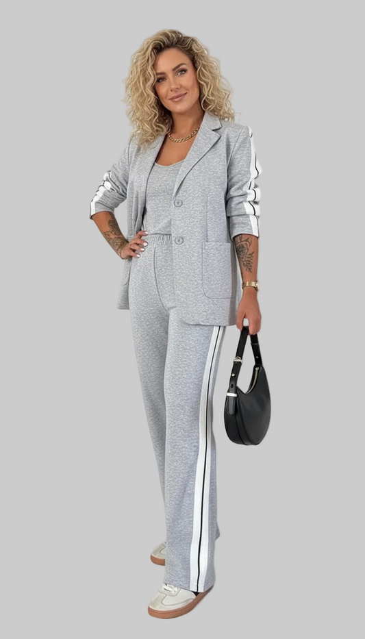 Woman wearing a gray suit with white stripes on a white background