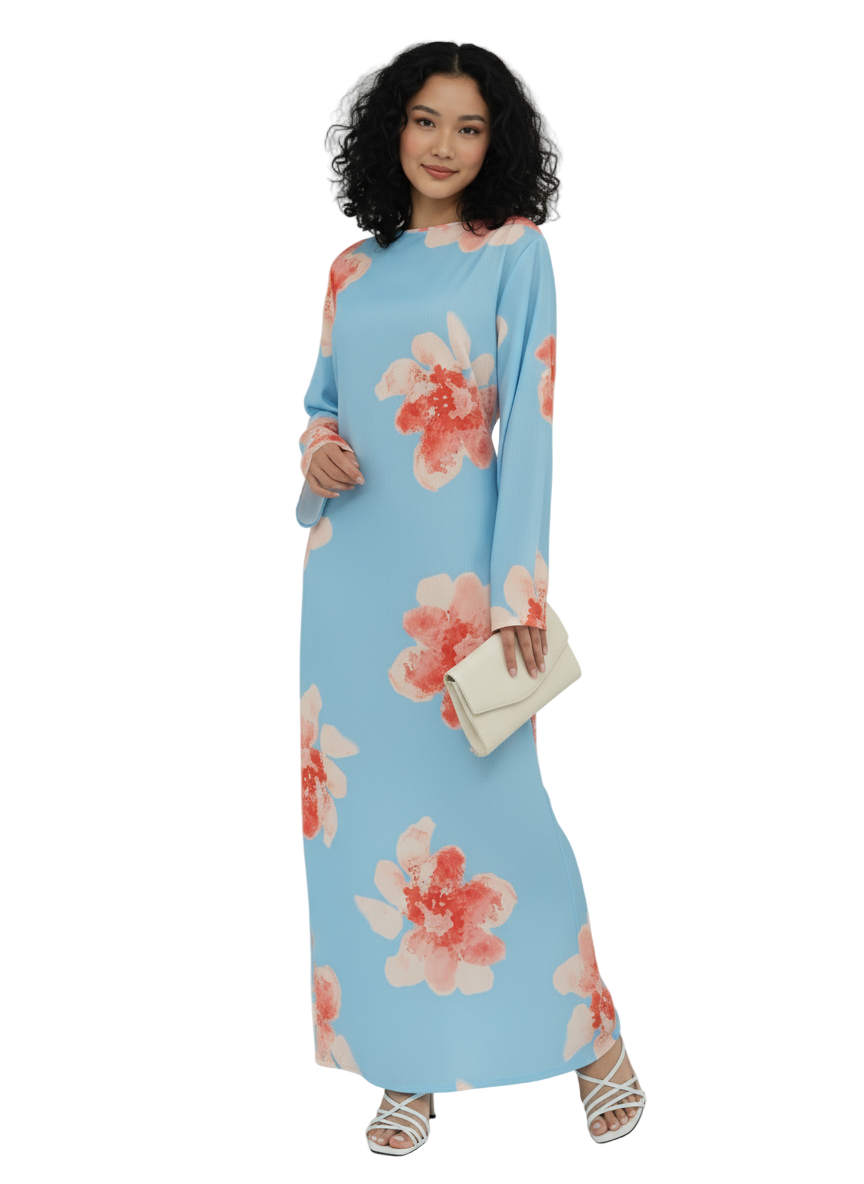 Woman wearing a light blue dress with pink floral patterns on a white background