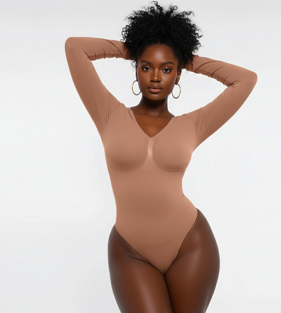 Woman wearing a beige bodysuit against a white background