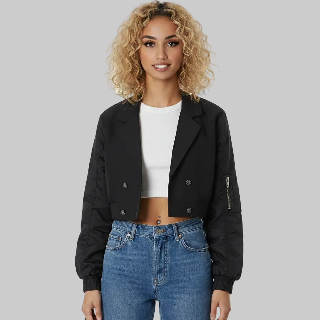 Woman wearing a black jacket, white top, and blue jeans on a white background