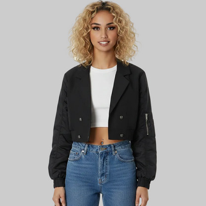 Woman wearing a black jacket, white top, and blue jeans on a white background