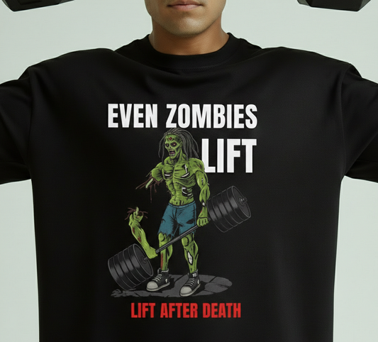 Black t-shirt with a graphic of a zombie lifting weights and text 'Even Zombies Lift' on a light gray background.