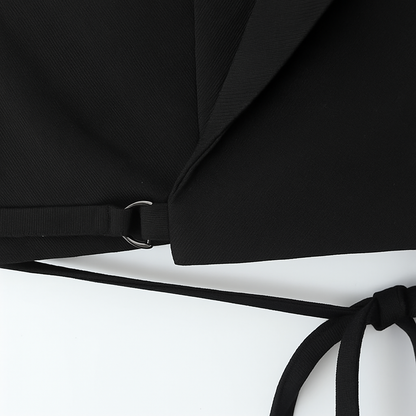 Black bikini top with a strap on a white background