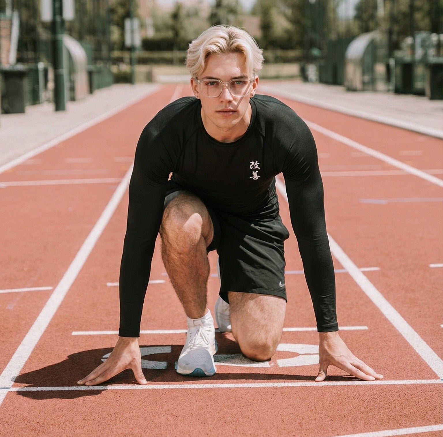 Person in athletic gear preparing to run on a track