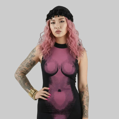 Person wearing a black and pink textured dress against a gray background