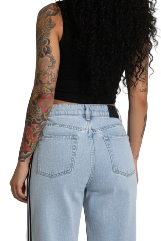 Person wearing light blue jeans with a white background