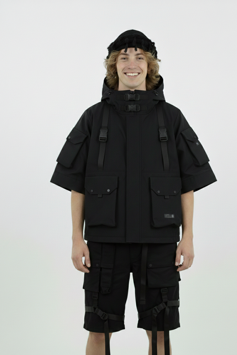 Person wearing a black tactical outfit with a white background