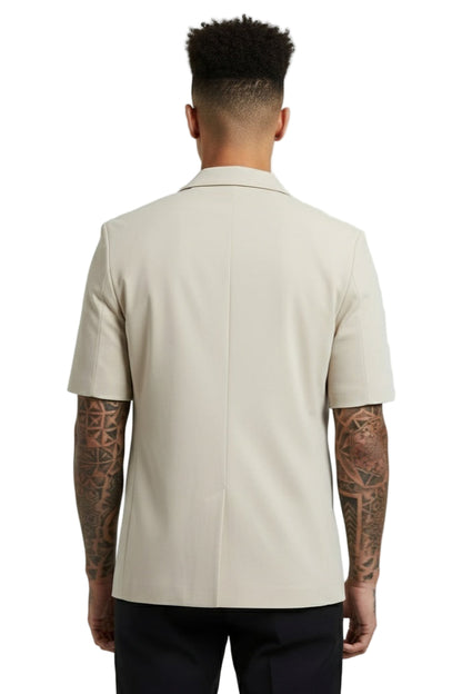 Man wearing a beige short-sleeve shirt on a plain background