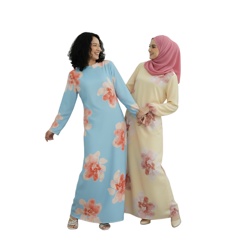 Two women wearing floral dresses standing against a white paneled wall.